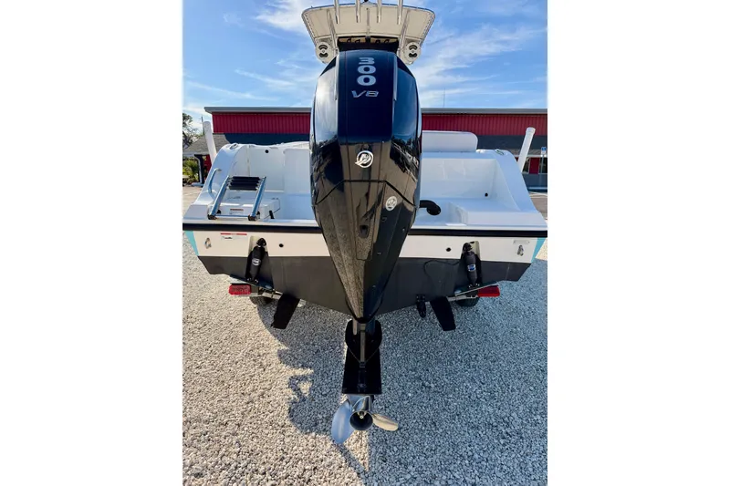 Slide: The Image of 2021 Cobia 237 Center Console boat with powerful 300 V8 engine, parked on gravel. - 35