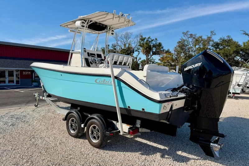 Slide: The Image of 2021 Cobia 237 Center Console boat with Mercury engine on trailer. - 6
