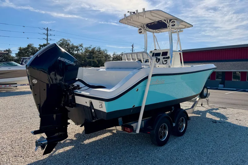 Slide: The Image of 2021 Cobia 237 Center Console boat with Mercury engine on trailer. - 8