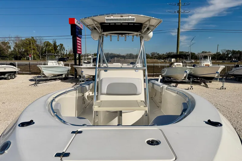 Slide: The Image of 2021 Cobia 237 Center Console boat displayed in a sunny outdoor showroom. - 9