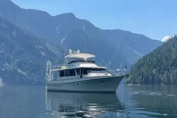 Slide: The Image of Offshore Yachts 2000 Flushdeck in serene mountain lake setting. - 1