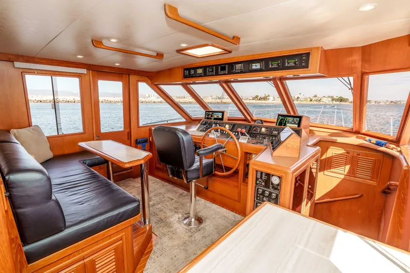 Slide: The Image of Luxurious 2000 Offshore Yachts Flushdeck interior with panoramic windows and elegant wood finish. - 18
