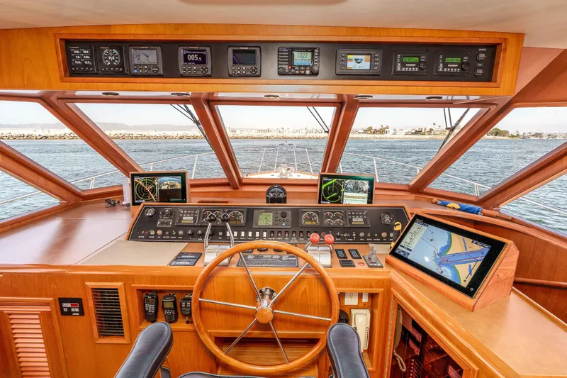 Slide: The Image of Helm of 2000 Offshore Yachts Flushdeck, featuring navigation instruments and panoramic sea view. - 19