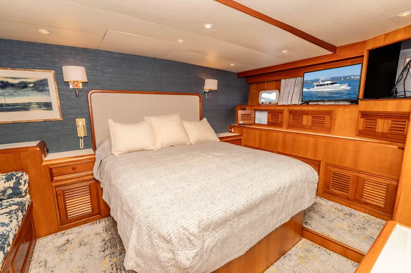 Slide: The Image of Luxurious 2000 Offshore Yachts Flushdeck bedroom with elegant wood finishes and cozy bedding. - 27