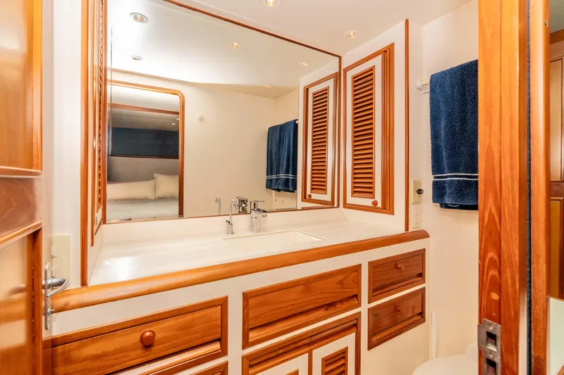 Slide: The Image of Luxurious bathroom in 2000 Offshore Yachts Flushdeck, featuring wood cabinetry and elegant fixtures. - 30