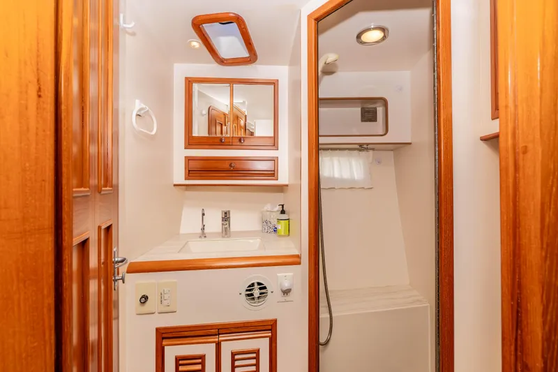 Slide: The Image of Luxurious bathroom in 2000 Offshore Yachts Flushdeck, featuring wood accents and modern fixtures. - 34