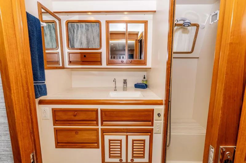 Slide: The Image of Luxurious 2000 Offshore Yachts Flushdeck bathroom with wooden cabinetry and modern fixtures. - 39