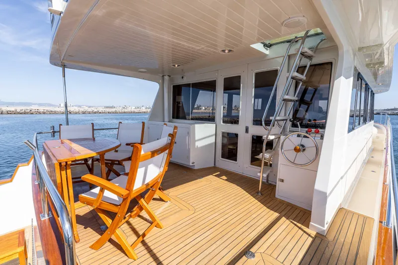Slide: The Image of Luxurious 2000 Offshore Yachts Flushdeck with teak deck and outdoor seating. - 4