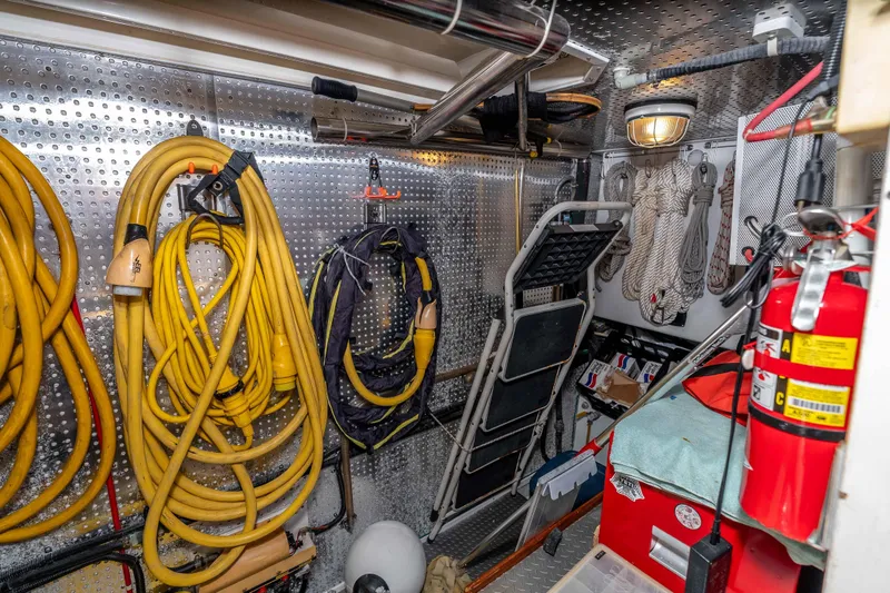 Slide: The Image of Storage area on 2000 Offshore Yachts Flushdeck with hoses, ropes, and fire extinguisher. - 42