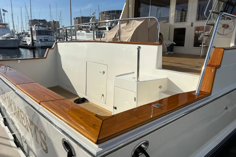 Slide: The Image of Luxurious 2000 Offshore Yachts Flushdeck with polished wood accents docked at marina. - 46