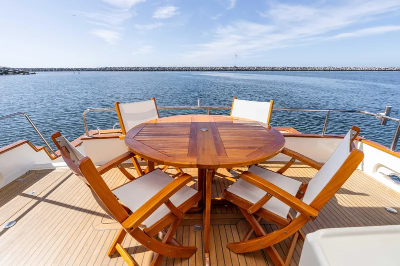 Slide: The Image of Luxurious 2000 Offshore Yachts Flushdeck with elegant wooden deck and seating, overlooking serene waters. - 7