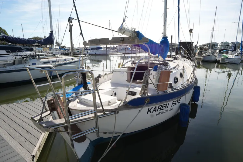 Slide: The Image of 1975 Westsail 32 sailboat docked in a marina, named "Karen Faye." - 1