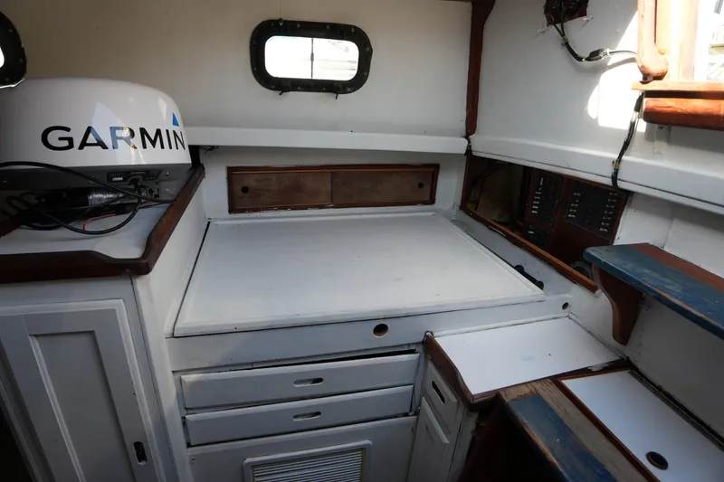 Slide: The Image of Interior of 1975 Westsail 32 sailboat with Garmin equipment and storage compartments. - 18