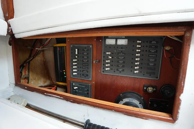 Slide: The Image of Electrical control panel inside a 1975 Westsail 32 sailboat, featuring various switches and gauges. - 19