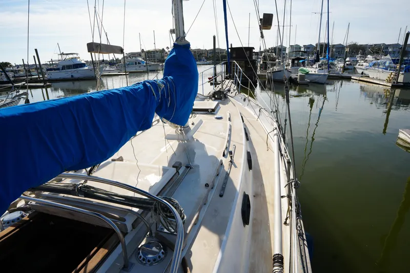 Slide: The Image of 1975 Westsail 32 sailboat docked in a marina, featuring a blue sail cover. - 5