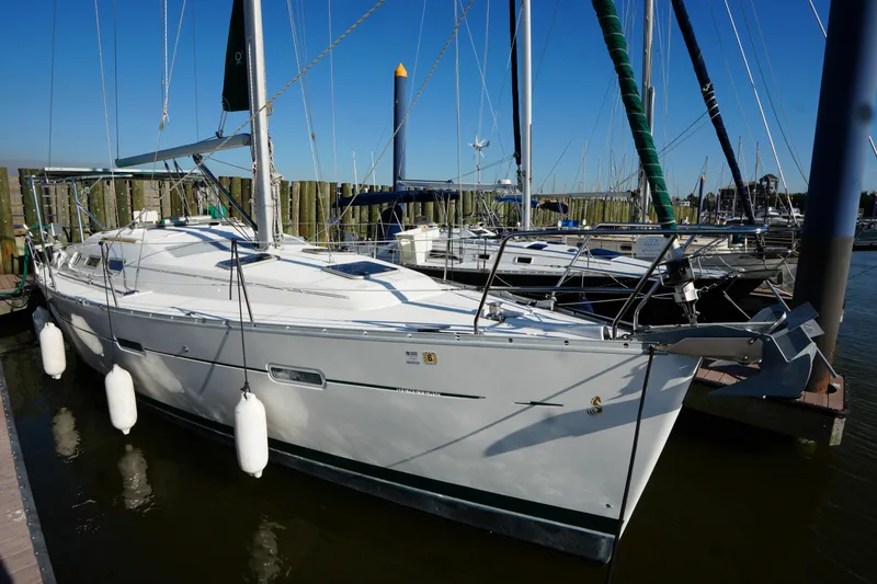 The Image of 2007 Beneteau 373 sailboat docked at marina, clear blue sky background. - 0