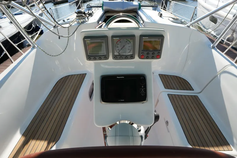 Slide: The Image of Cockpit of 2007 Beneteau 373 sailboat with navigation instruments and teak flooring. - 10