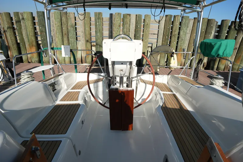 Slide: The Image of Cockpit of 2007 Beneteau 373 sailboat with wooden seating and steering wheel. - 13