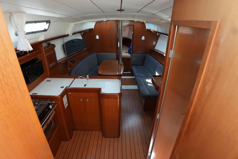 Slide: The Image of Interior of 2007 Beneteau 373 sailboat with wood finish and cozy seating area. - 14