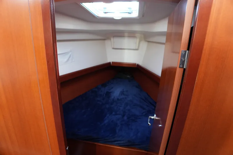 Slide: The Image of Cozy cabin interior of 2007 Beneteau 373 sailboat with wooden finish and skylight. - 15