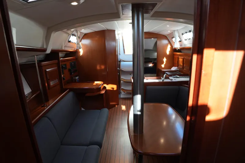 Slide: The Image of Interior of 2007 Beneteau 373 sailboat with wood finish and seating area. - 16