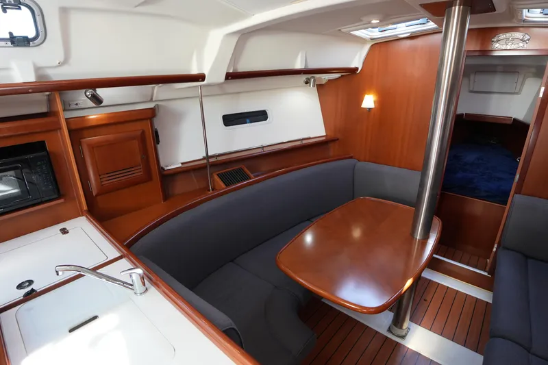 Slide: The Image of Interior of 2007 Beneteau 373 sailboat with wood finish and cozy seating area. - 17