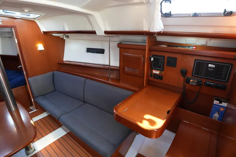 Slide: The Image of Interior of 2007 Beneteau 373 sailboat with wood finish and navigation station. - 18