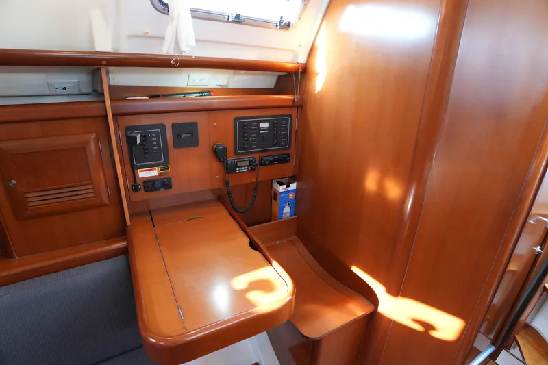 Slide: The Image of 2007 Beneteau 373 yacht interior with navigation station and wooden cabinetry. - 19
