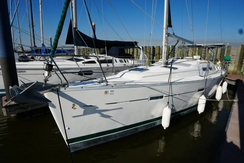 Slide: The Image of 2007 Beneteau 373 sailboat docked, featuring sleek white hull and rigging. - 3