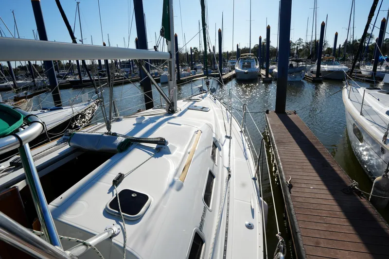 Slide: The Image of 2007 Beneteau 373 sailboat docked at marina, surrounded by other boats. - 7