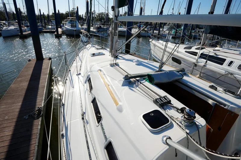 Slide: The Image of 2007 Beneteau 373 sailboat docked at marina, showcasing sleek deck design. - 8