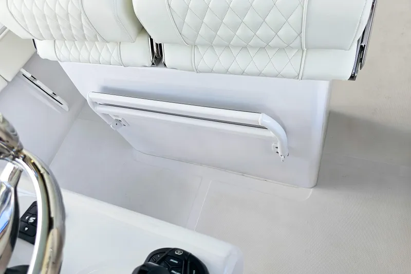 Slide: The Image of White leather seating on 2026 Jupiter 26 boat, featuring quilted design and sleek controls. - 13