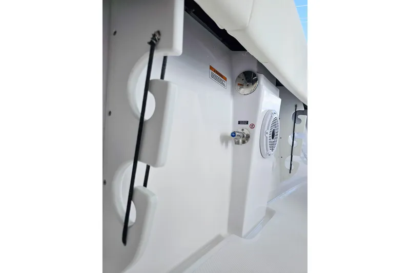 Slide: The Image of Interior view of 2026 Jupiter 26 boat, featuring storage compartments and speaker system. - 20