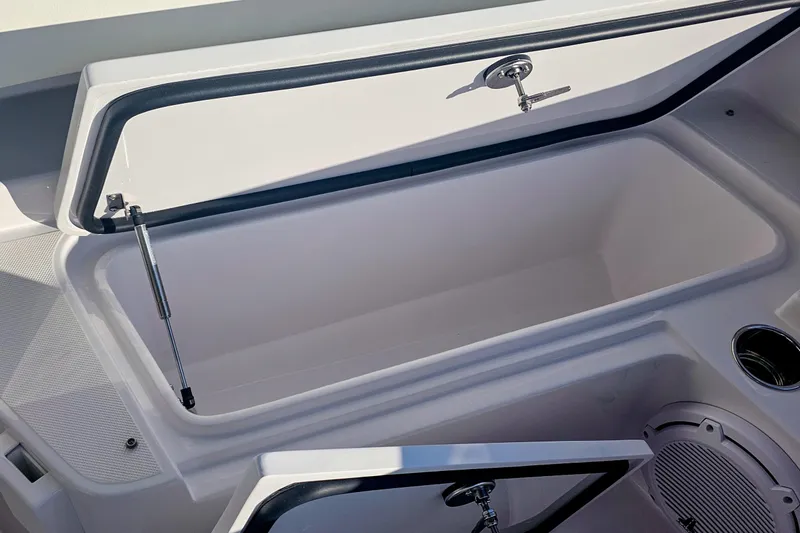 Slide: The Image of Open storage compartment on a 2026 Jupiter 26 boat, featuring sleek design and modern hardware. - 17
