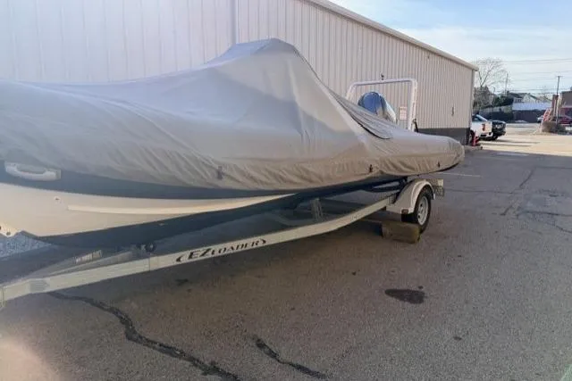 Slide: The Image of 2019 Highfield 640 Deluxe boat covered on trailer in parking lot. - 10