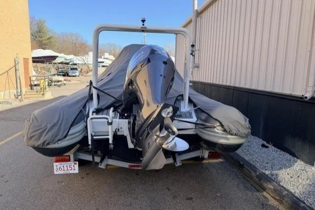 Slide: The Image of 2019 Highfield 640 Deluxe boat covered and parked on a trailer. - 12