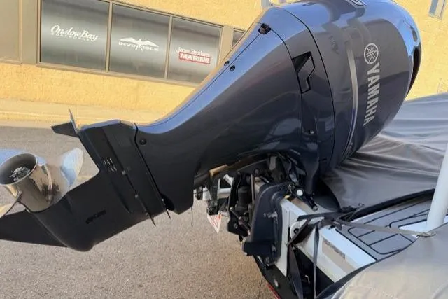 Slide: The Image of 2019 Highfield 640 Deluxe boat with Yamaha outboard motor, parked near marine shop. - 13