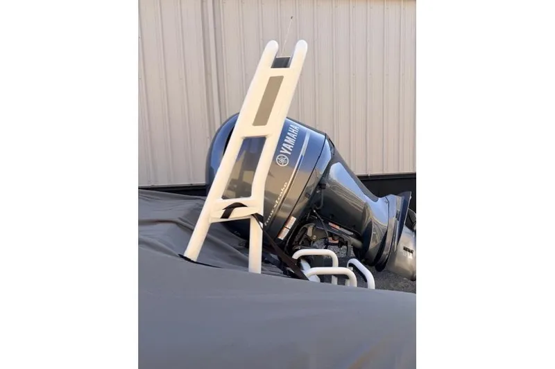 Slide: The Image of 2019 Highfield 640 Deluxe with Yamaha outboard motor, covered and stored. - 15