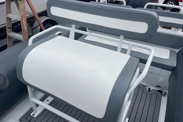 Slide: The Image of 2019 Highfield 640 Deluxe boat seat with gray and white upholstery. - 17