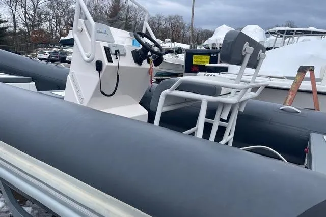 Slide: The Image of 2019 Highfield 640 Deluxe inflatable boat with console and seating, parked outdoors. - 23