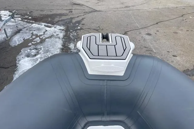 Slide: The Image of 2019 Highfield 640 Deluxe boat bow on snowy pavement background. - 27