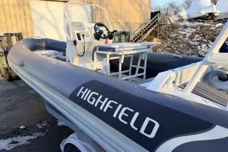 Slide: The Image of 2019 Highfield Patrol 660 boat with sleek design, docked outdoors. - 6