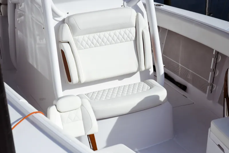 Slide: The Image of Luxurious seating on 2026 Jupiter 30 boat with white quilted upholstery. - 10
