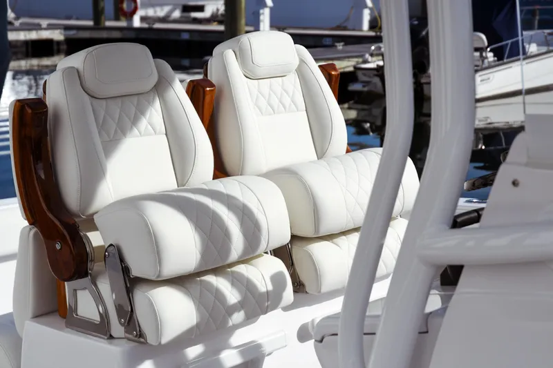 Slide: The Image of Luxurious white leather seats on a 2026 Jupiter 30 boat, featuring elegant stitching. - 11