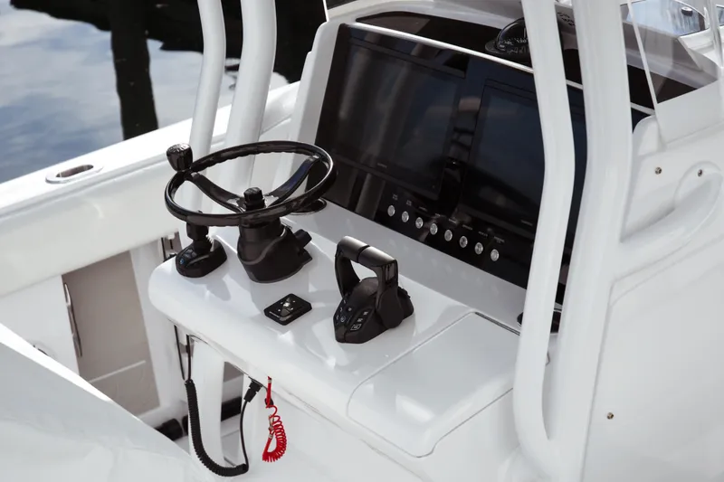 Slide: The Image of Helm of 2026 Jupiter 30 boat with steering wheel and control panel. - 12