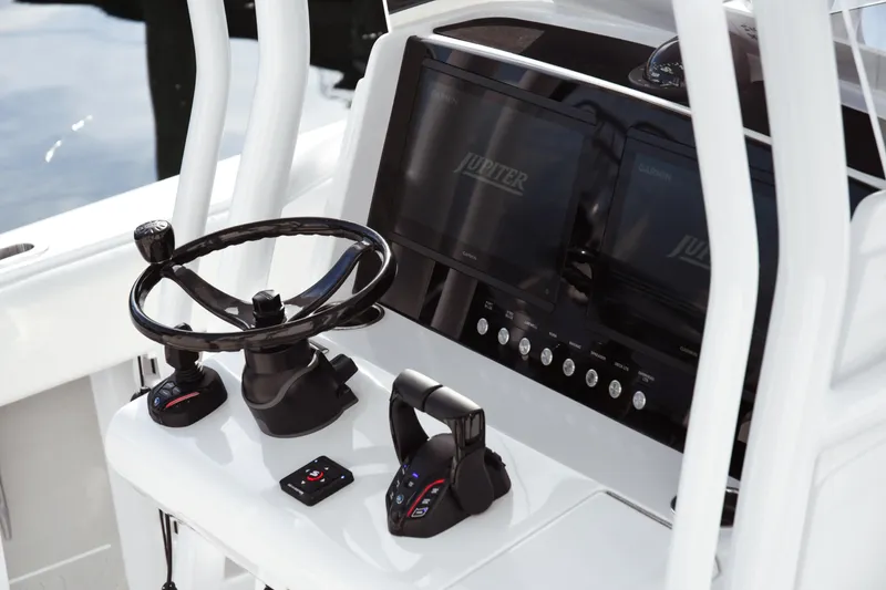Slide: The Image of Helm of 2026 Jupiter 30 boat with steering wheel and control panel. - 13