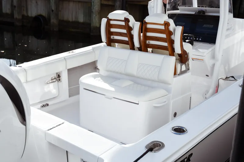 Slide: The Image of 2026 Jupiter 30 boat interior with white seating and wooden accents. - 14