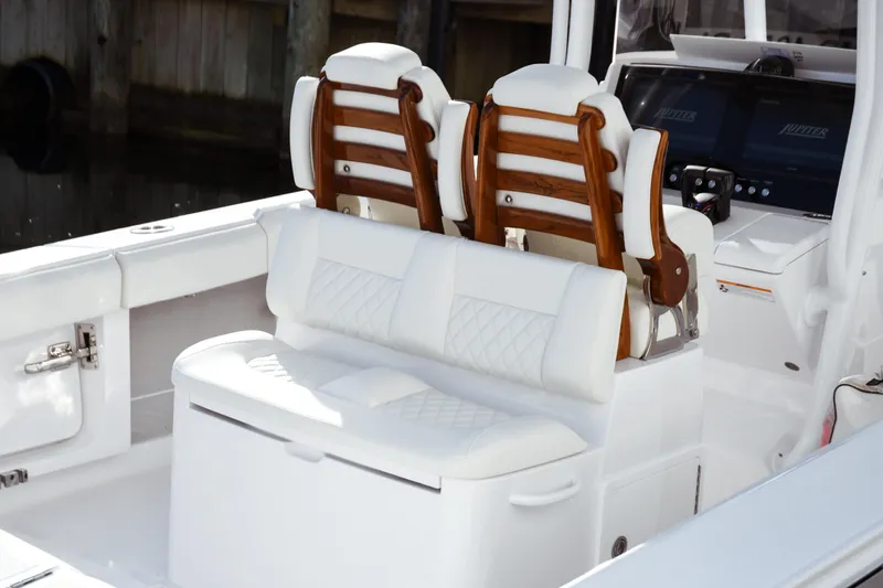 Slide: The Image of Luxury seating on a 2026 Jupiter 30 boat, featuring elegant white upholstery. - 15
