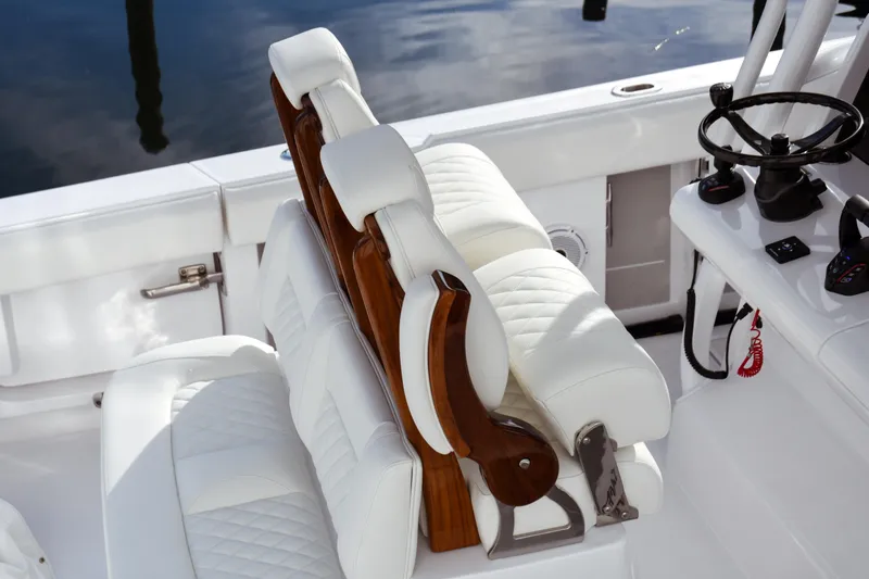 Slide: The Image of Luxurious white seating and helm of 2026 Jupiter 30 boat, featuring elegant design. - 18
