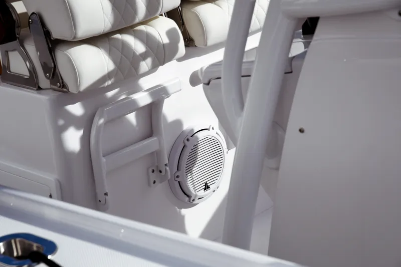Slide: The Image of Interior of 2026 Jupiter 30 boat featuring white seating and speaker system. - 19